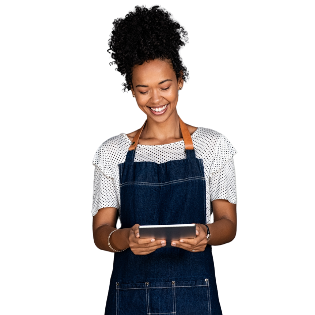 A Woman At Home Wearing An Apron And Holding A Tablet.